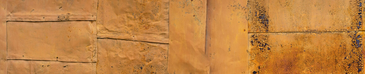 Panorama with orange iron sheets. Texture of old rusty painted metal. Metal corrosion. Template for the designer, banner