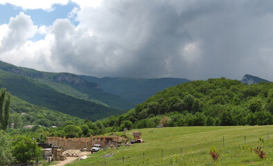 Fototapeta na wymiar Summer landscape and construction in the countryside in the mountains on the Crimean peninsula