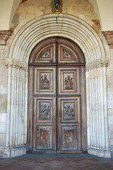Fototapeta na wymiar View of Santa Maria di Chiaravalle wood entrance door