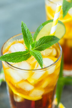  Homemade peach ice tea with ice, lime and mint in the glass