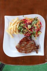 grilled pork or Barbecued pork with salad and French fries