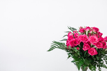 Bouquet of pink flowers on white background and space