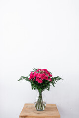 Bouquet of pink flowers on white background and space