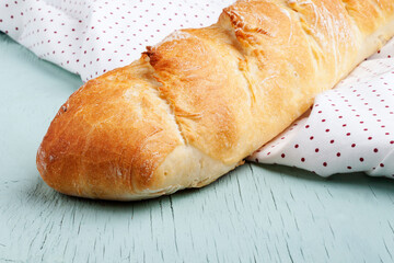 freshly baked baguette on the kitchen table. Fresh bread