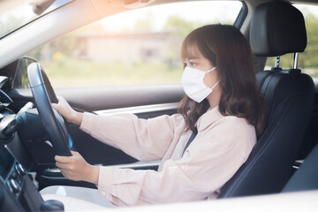 Beautiful Asian woman driving car wearing facemask going outside stay healthy protective from coronavirus covid-19 virus infection disease outbreak world pandemic, traffic air pollution emission