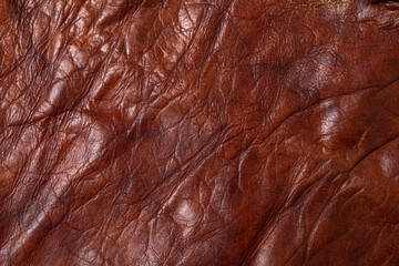 Crumpled brown leather texture. Beautiful and shiny skin