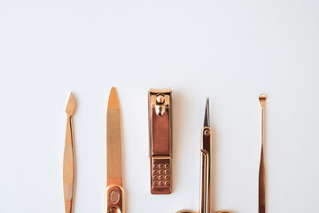 Tools of a manicure set on a white background. Gold color tools