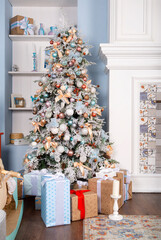 Christmas decorated fir tree in a room with a fireplace,  light blue room, interior