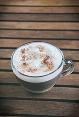 Cappuccino in transparent cup with copy space