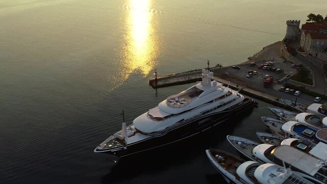 Big luxury yacht in port or marina during sunset. France, Monaco, Croatia, Italy, Porto Fino during summer season, yacht week. 
