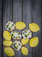 Lemon cookies decorated with royal icing on wooden background