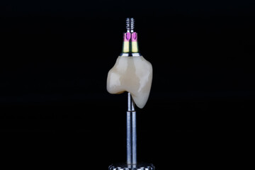 made by a dental technician zircon crown for orthopedic screwdriver, shot on a black background