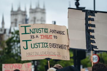 Black Lives Matter protest in London. Injustice banner - obrazy, fototapety, plakaty