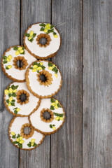 Lemon wreath cookies decorated with royal icing on wooden backgrond