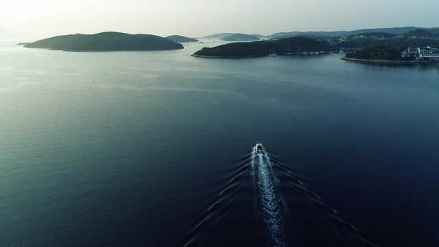 Aerial view of luxury speed boat sailing in Mediterranean sea in Europe. Sailing experience on a yacht in France, Monaco, Italy or Croatia.Sun reflection on a calm surface of the sea.