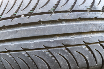 Damaged and worn old black tires on a stack. Damaged and worn old black tires on a stack. Tire...