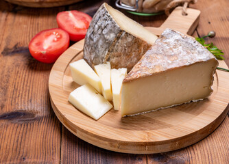 Cheese tomme de montagne or tomme de savoie made from cow milk in French Alps.