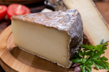 Cheese tomme de montagne or tomme de savoie made from cow milk in French Alps.