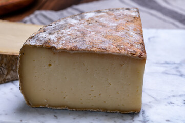 Cheese tomme de montagne or tomme de savoie made from cow milk in French Alps.