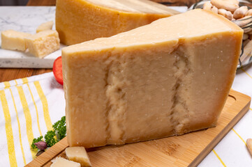 Big wedges of parmigiano-reggiano parmesan hard Italian cheese made from cow milk or Grana Padano