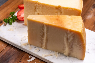 Big wedges of parmigiano-reggiano parmesan hard Italian cheese made from cow milk or Grana Padano