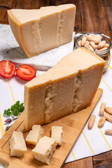 Big wedges of parmigiano-reggiano parmesan hard Italian cheese made from cow milk or Grana Padano