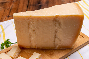 Big wedge of parmigiano-reggiano parmesan hard Italian cheese made from cow milk or Grana Padano