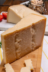 Big wedges of parmigiano-reggiano parmesan hard Italian cheese made from cow milk or Grana Padano