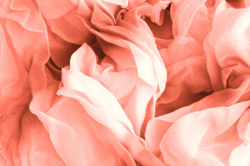Texture of coral Wrinkled Fabric. Trendy color of clothes. Close-up.