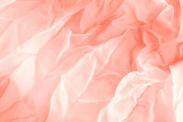 Texture of coral Wrinkled Fabric. Trendy color of clothes. Close-up.