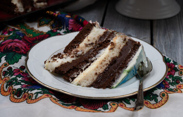 Slice of chocolate and vanilla cake on a country style napkin