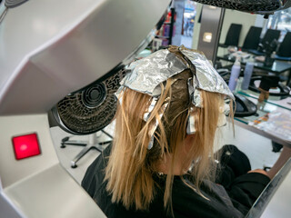 Hairdresser dyeing a womans hair