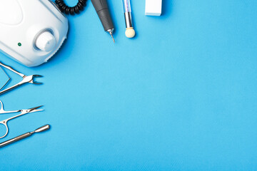 Professional manicure tools on blue background.
