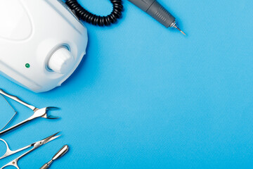 Professional manicure tools on blue background..