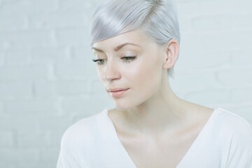 Fototapeta premium Closeup portrait of daydreaming young woman with short hair.