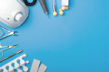 Professional manicure tools on blue background..