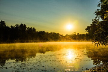 Fog above the water surface. Sunrise at river