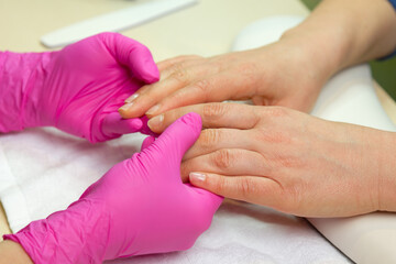 Obraz na płótnie Canvas Closeup shot of a woman in a nail salon. Woman getting nail manicure..