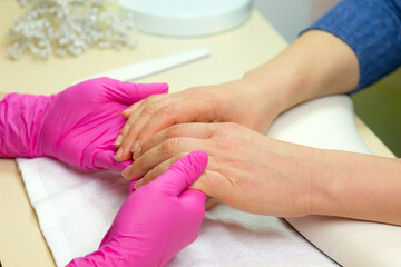 Obraz na płótnie Canvas Closeup shot of a woman in a nail salon. Woman getting nail manicure..