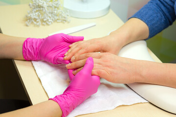 Closeup shot of a woman in a nail salon. Woman getting nail manicure..