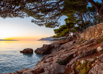 sunset over the Adriatic Sea and the coastline in Brela, Croatia