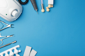Professional manicure tools on blue background.