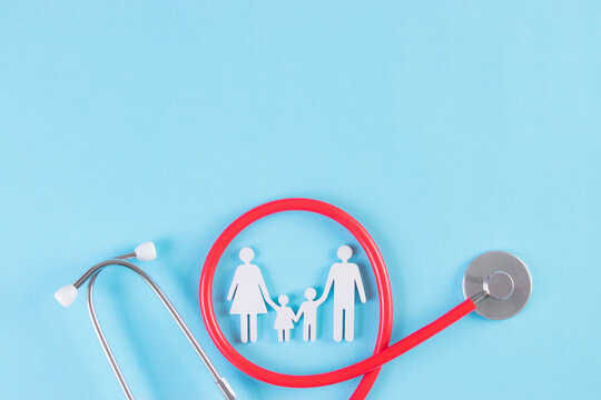 Family figure wrapped with stethoscope on light blue background. Insurance concept or Covid-19 concept.