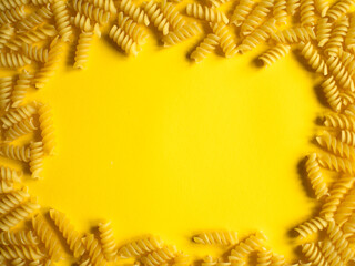 wheat macaroni frame on yellow background