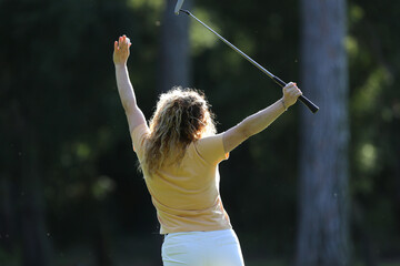 woman celebrating golf