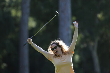 woman celebrating golf