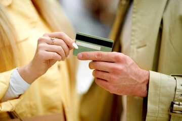 handsome kind man give credit card to wife, young lady going to go shopping, she is shopaholic