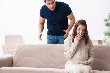 Man and pregnant woman in antismoking concept