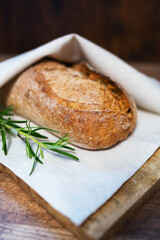 Freshly baked bread wrapped in a towel.