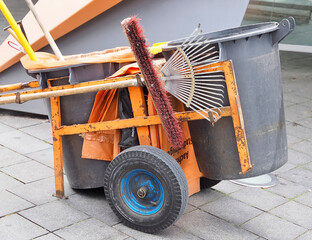 Orange car of a street cleaner with tolls for work